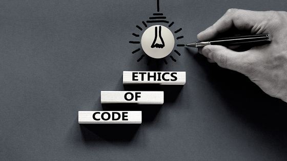 An image of a person writing the word ethics of code.