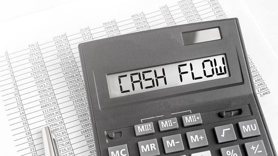 A calculator with the word cash flow written on it.